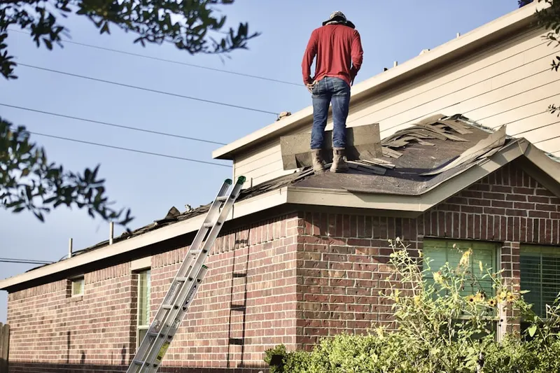 Professional roofer working on a residential roof in Walesville